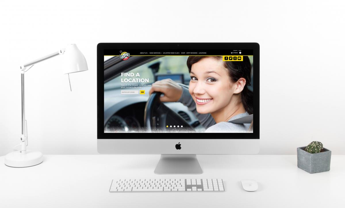 Zips Car Wash website mocked up on computer sitting on white desk