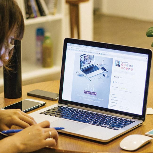 a woman at a desk with a laptop